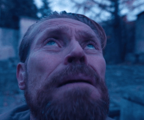 A Man With A Beard And Blue Eyes Looks Up At The Sky GIF