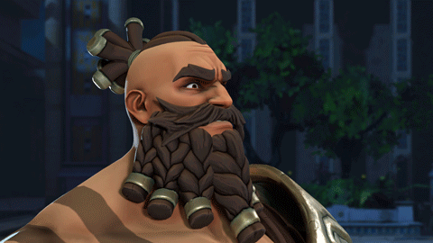 A Man With A Beard And Braided Hair Is Pointing To His Forehead GIF