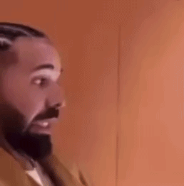 A Man With A Beard And Braids Is Wearing Earrings And A Jacket . GIF