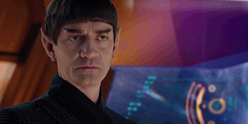 A Man With A Beard And Ears Is Looking At Something GIF
