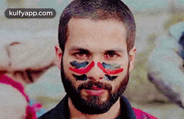 A Man With A Beard And Face Paint On It . GIF
