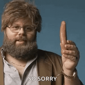 A Man With A Beard And Glasses Is Holding A Sausage In His Hand And Says So Sorry . GIF