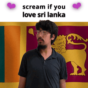 A Man With A Beard And Glasses Is Standing In Front Of A Sri Lanka Flag GIF