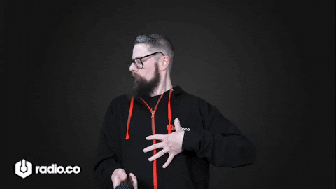 A Man With A Beard And Glasses Is Wearing A Black Hoodie With The Word Radio.co On It GIF