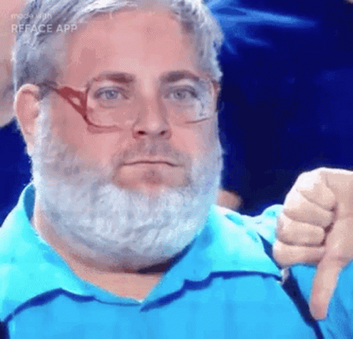 A Man With A Beard And Glasses Is Wearing A Blue Shirt And Giving A Thumbs Down Sign . GIF