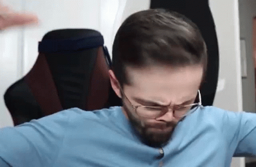 Bearded Man In Blue Shirt Sitting GIF
