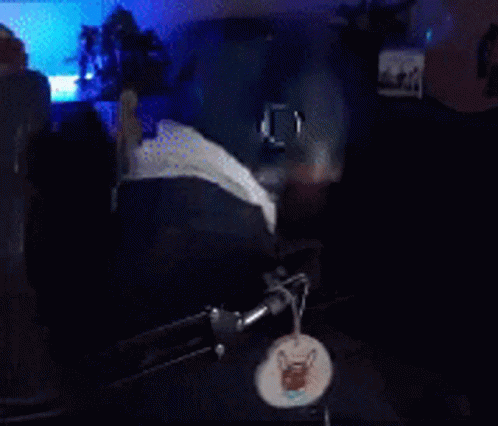 A Man With A Beard And Glasses Is Wearing Headphones And A Hat GIF