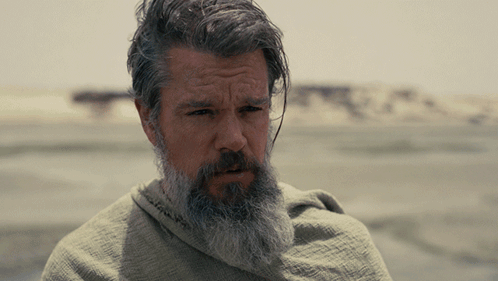 A Man With A Beard And Gray Hair Is Wrapped In A Cloth GIF