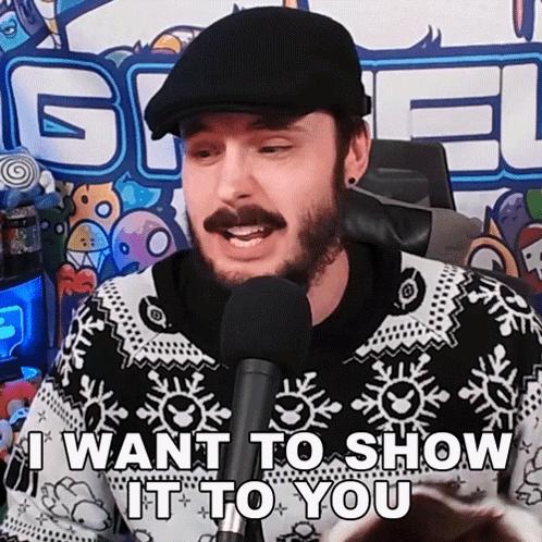 A Man With A Beard And Hat Is Talking Into A Microphone And Saying I Want To Show It To You . GIF