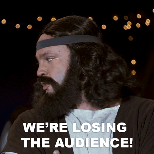 a man with a beard and headband is saying we 're losing the audience