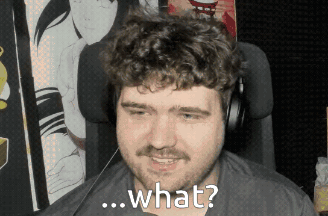 a man with a beard and headphones is smiling and asking what