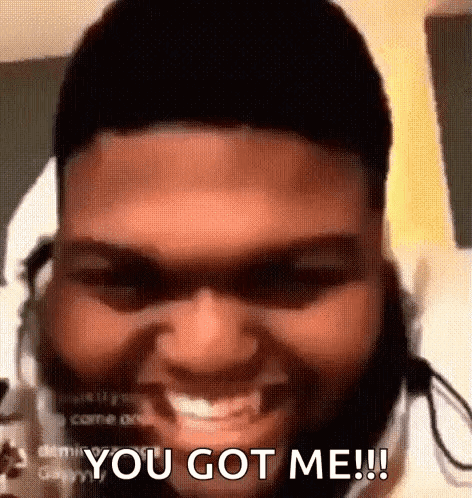 A Man With A Beard And Headphones Is Smiling And Saying `` You Got Me '' . GIF