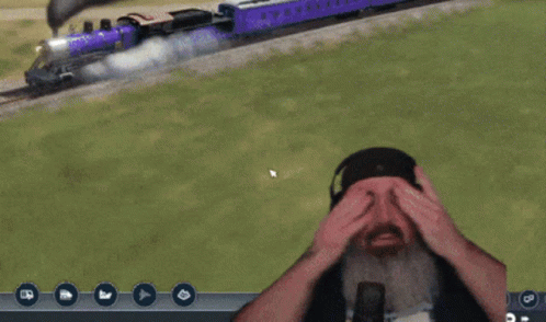 A Man With A Beard And Headphones Says " Hey " In Front Of A Train GIF