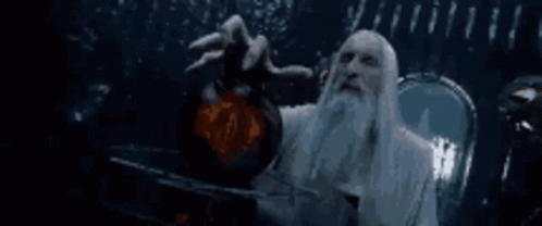 A Man With A Beard And Long White Hair Is Holding A Sphere In His Hand . GIF