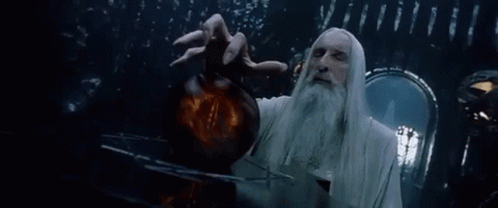 A Man With A Beard And Long White Hair Is Holding A Sphere In His Hand . GIF