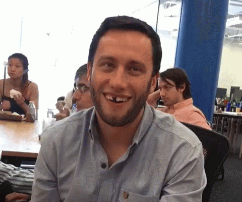 A Man With A Beard And Missing Teeth Is Smiling GIF