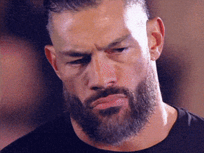 A Man With A Beard And Mustache Is Making A Funny Face . GIF