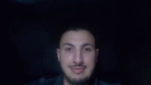 a man with a beard and mustache is pointing up with his finger