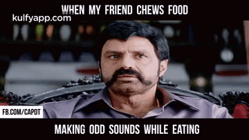 A Man With A Beard And Mustache Is Sitting In A Chair . GIF