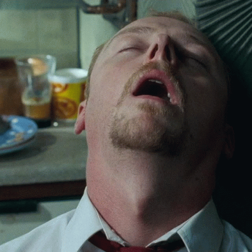 A Man With A Beard And Mustache Is Sleeping With His Mouth Open GIF