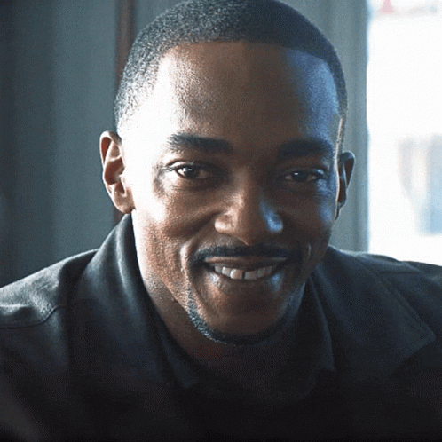 A Man With A Beard And Mustache Is Smiling GIF