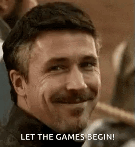 A Man With A Beard And Mustache Is Smiling And Saying `` Let The Games Begin ! '' GIF