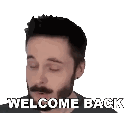 a man with a beard and mustache is smiling and says welcome back
