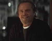 A Man With A Beard And Mustache Is Smiling . GIF