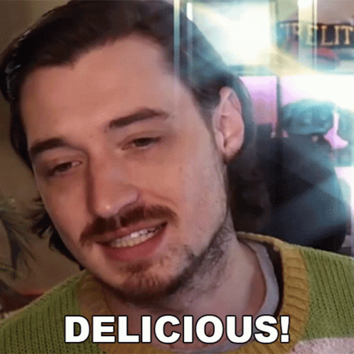 a man with a beard and mustache is smiling with the words delicious below him