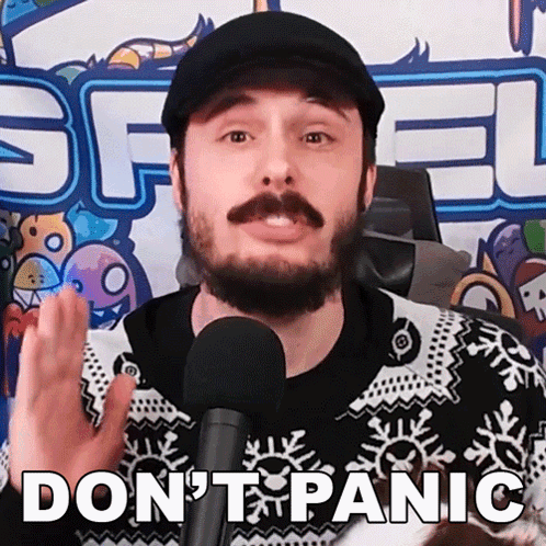 A Man With A Beard And Mustache Is Talking Into A Microphone With The Words " Do N't Panic " Above Him GIF