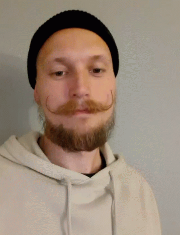 A Man With A Beard And Mustache Is Wearing A Black Hat And Giving A Thumbs Up GIF