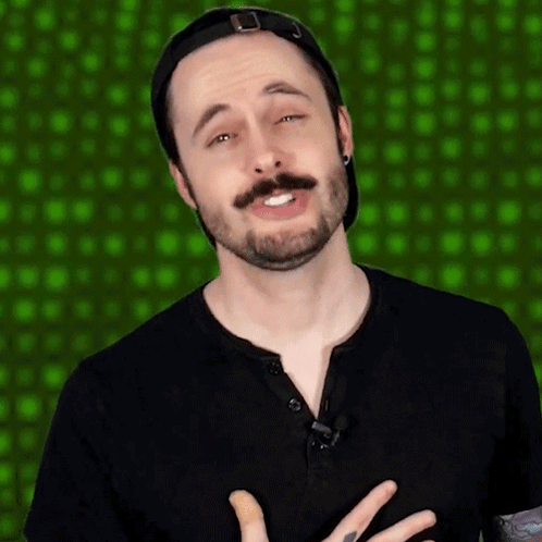 Man With Beard And Mustache In Black Shirt And Baseball Cap GIF