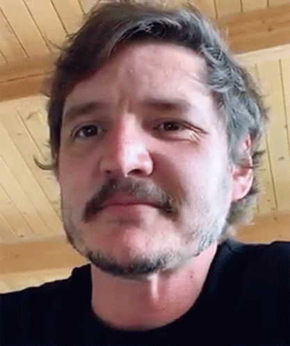 A Man With A Beard And Mustache Is Wearing A Black Shirt GIF