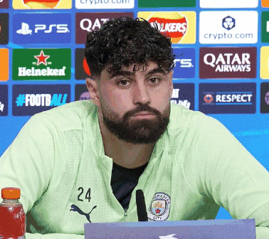 a man with a beard and the number 24 on his jacket