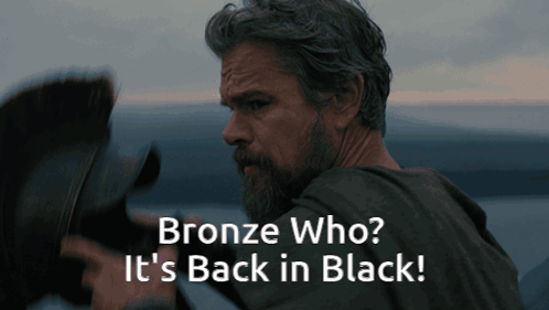 A Man With A Beard And The Words Bronze Who It 'S Back In Black Below Him GIF