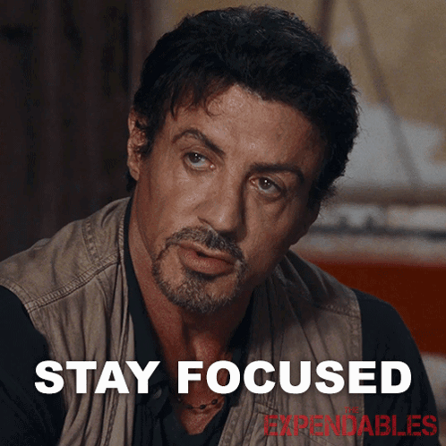 A Man With A Beard And The Words Stay Focused Behind Him GIF