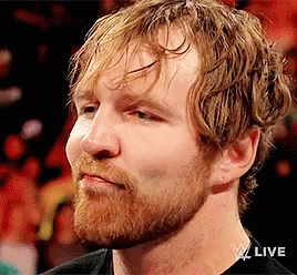 A Man With A Beard And Wet Hair Is Wearing A Black Shirt And Looking At The Camera . GIF