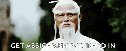 A Man With A Beard And White Hair Is Standing In Front Of Trees And Says `` Get Assignments Turned In '' . GIF