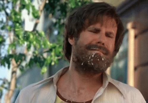 A Man With A Beard Has A Few Drops Of Milk On His Face GIF