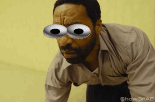 A Man With A Beard Has Googly Eyes On His Face And The Watermark Show3rae GIF