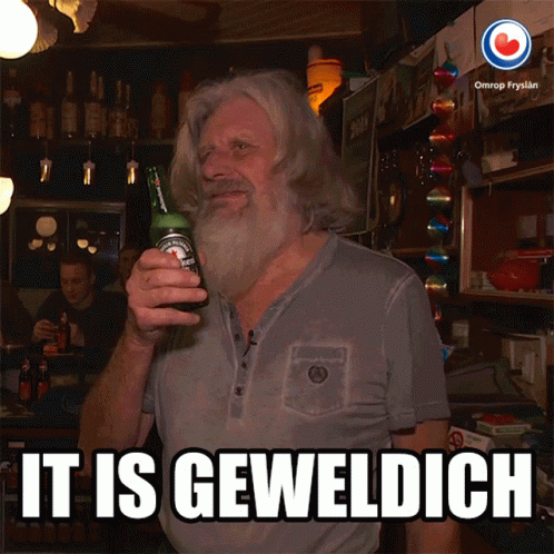 A Man With A Beard Holds A Bottle Of Beer And Says It Is Geweldigch GIF