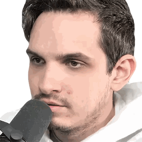 a man with a beard holds a microphone in his mouth