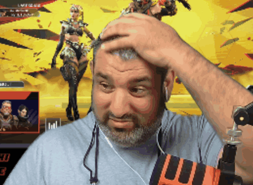 A Man With A Beard Holds His Hand To His Forehead In Front Of A Screen That Says Legends GIF