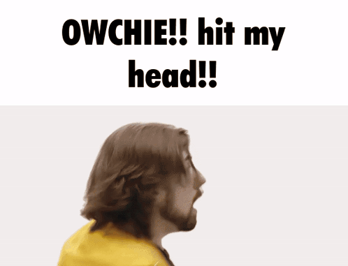 A Man With A Beard Holds His Hand To His Forehead With The Words Owchie Hit My Head Below Him GIF