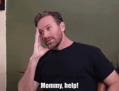 A Man With A Beard Holds His Hand To His Head And Says Mommy Help GIF