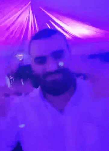 A Man With A Beard In A Purple Room GIF