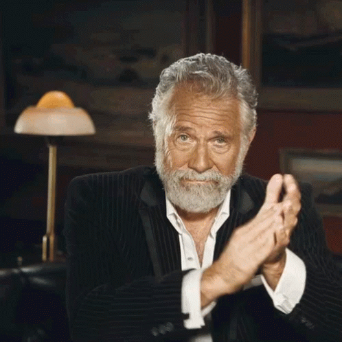 A Man With A Beard In A Suit Is Clapping His Hands GIF