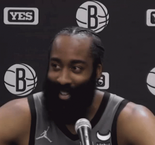 A Man With A Beard In Front Of A Yes Logo GIF