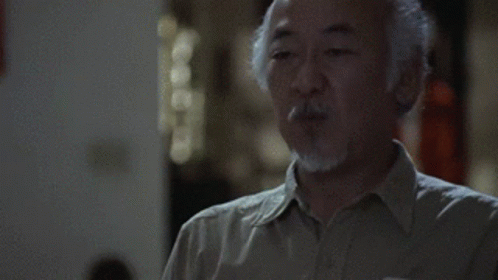 A Man With A Beard Is Blowing A Kiss GIF