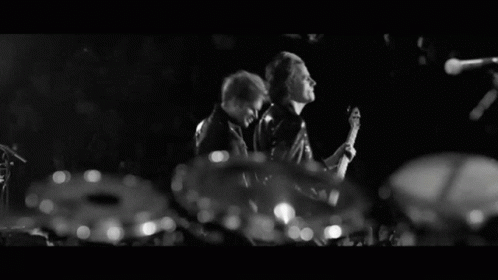 A Man With A Beard Is Clapping His Hands In The Dark GIF